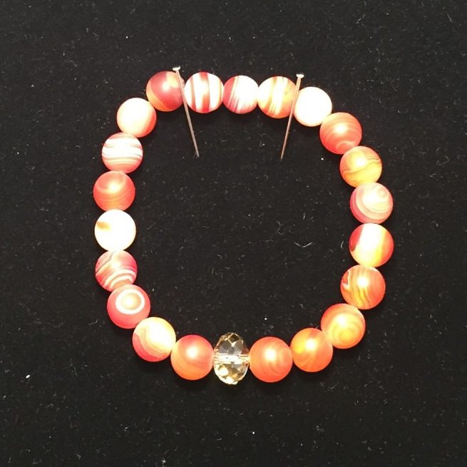 This bracelet is made out of agates and crystals