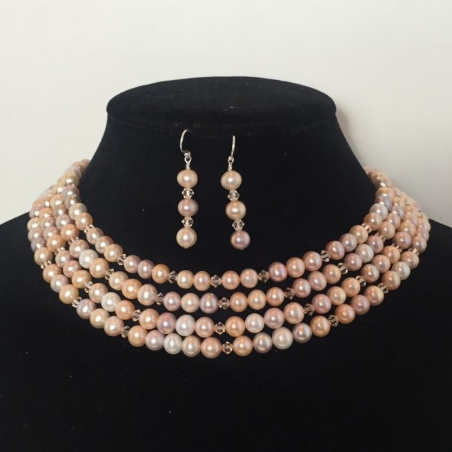 Set of earrings and strands of a beautiful necklace made with pearls and crystals